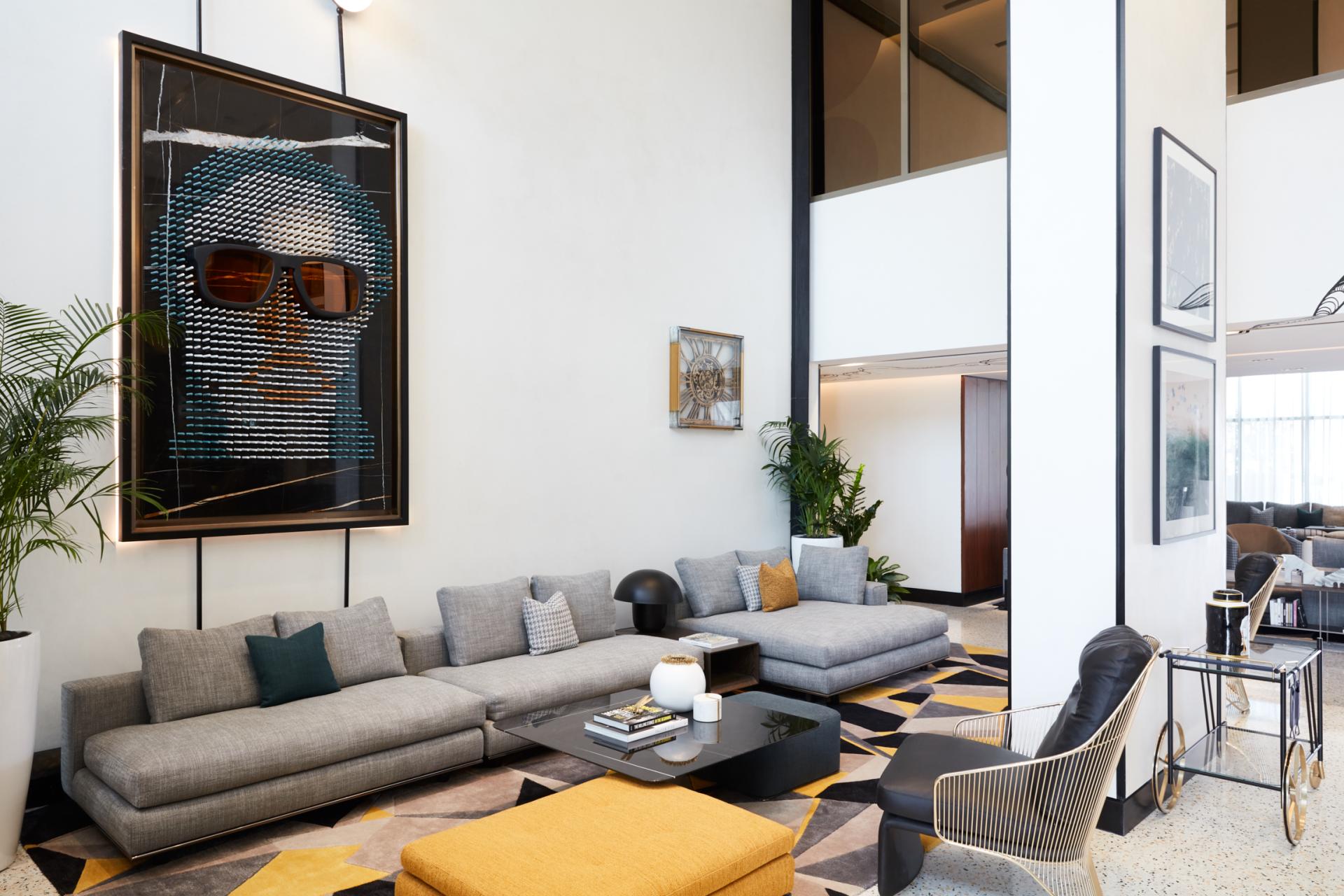 Contemporary living area at The8 Hotel in Dubai featuring modern art, stylish furniture, and a vibrant color palette.