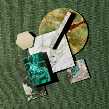 Natural stone samples from SolidNature's Green Stone Collection, showcasing unique textures and vibrant green hues against a green background.