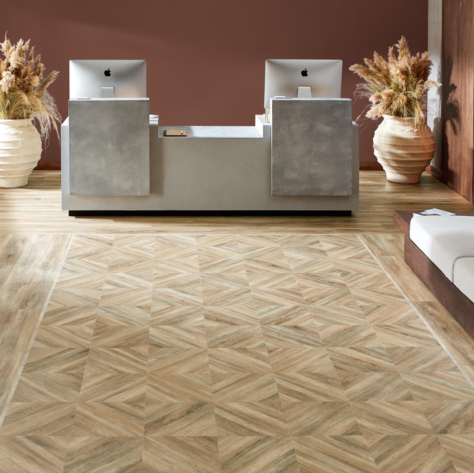 Amtico's Signature flooring features a geometric pattern, enhancing the modern aesthetic of a stylish reception area.