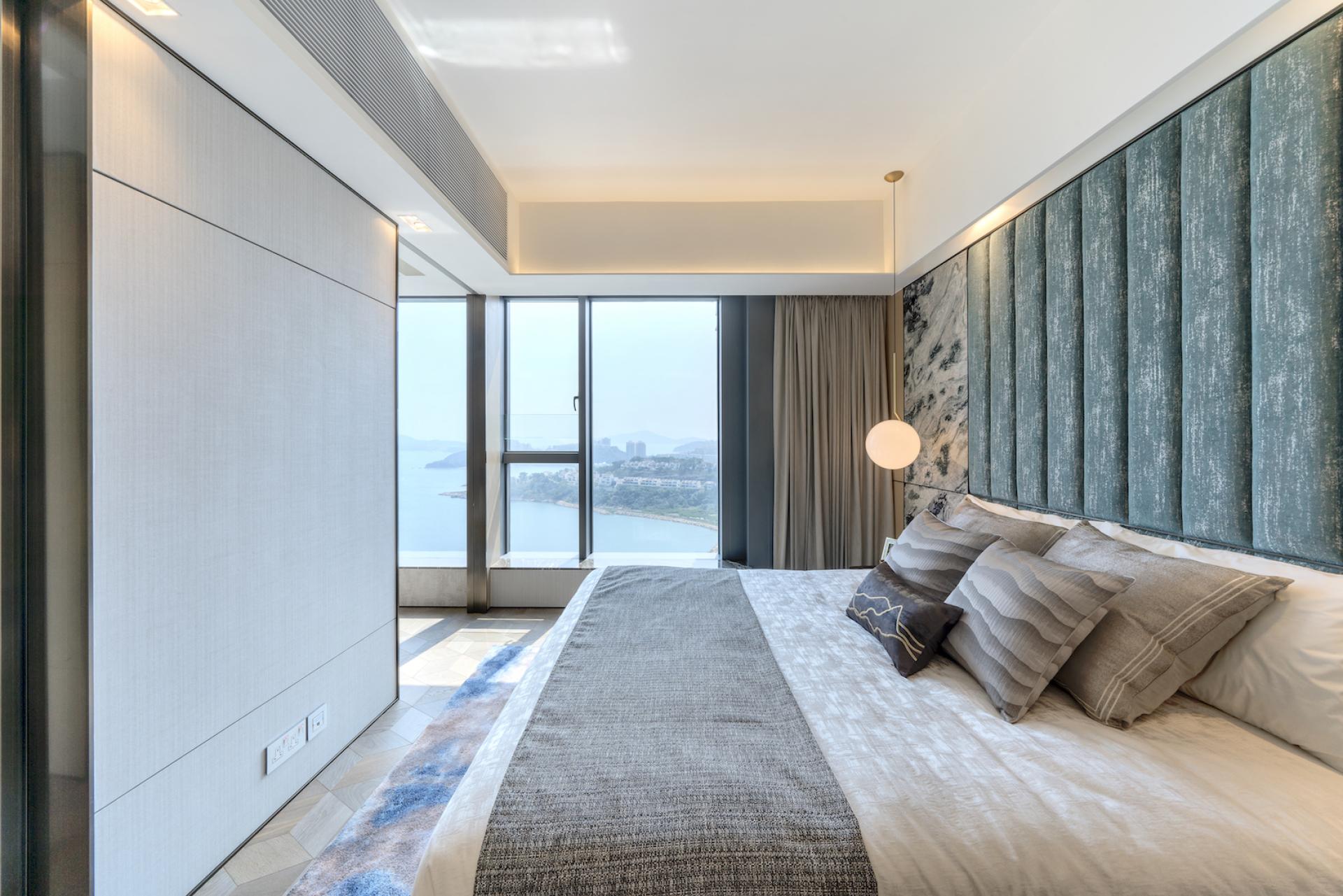Modern Hong Kong bedroom featuring elegant decor, bay window views, and a serene color palette inspired by Chinese philosophy.