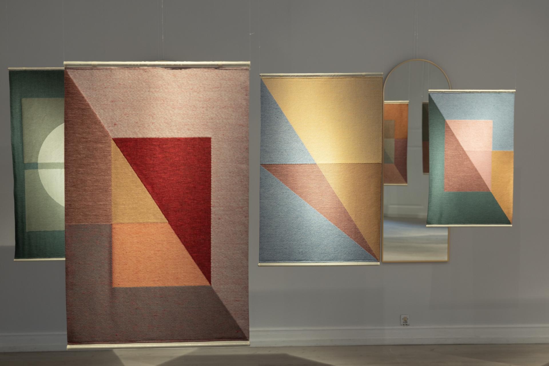 Colorful patterned textiles with geometric designs displayed at Material Matters during London Design Festival 2023.