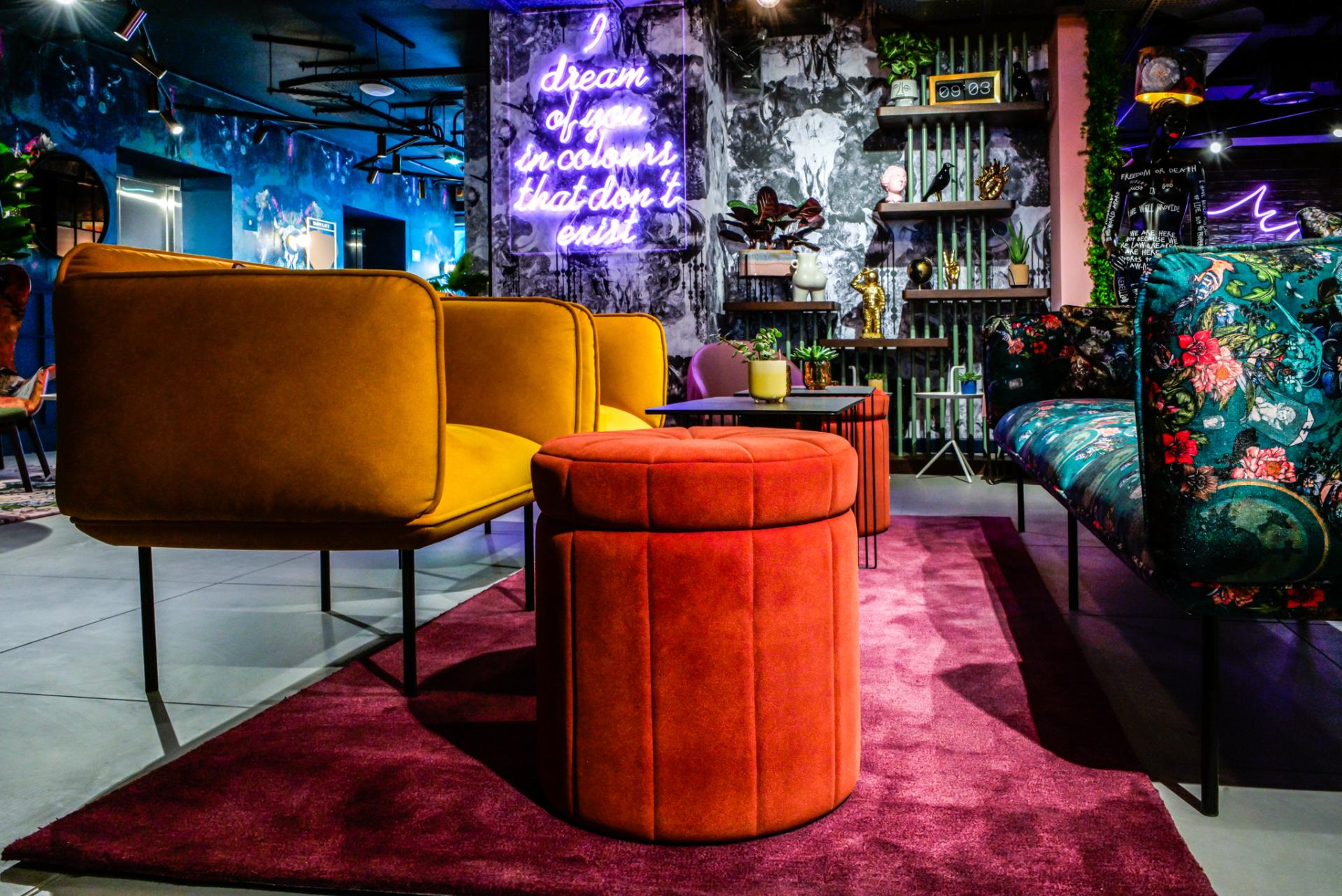 Vibrant seating and decor in BOBO1325's bold interior design at Manchester's Qbic hotel, featuring colorful furniture and artwork.