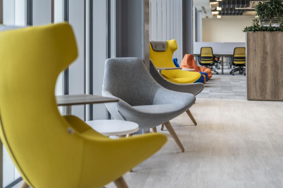 Innovative office furniture in vibrant colors designed for comfort and creativity in the AMH Workspace.