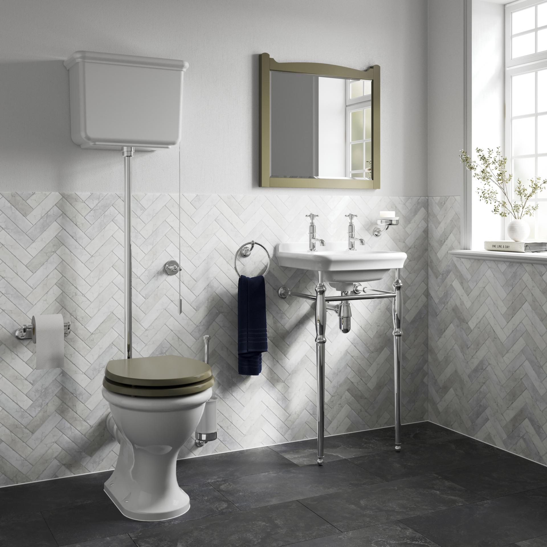 Elegant bathroom featuring Arts & Crafts inspired fixtures, herringbone tile wall, and stylish ceramic sink with chrome accents.