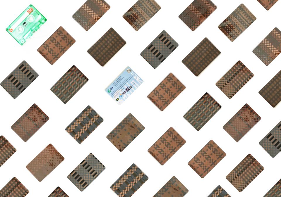 Colorful cassette tapes and cards arranged in a pattern, highlighting Rehyphen®'s up-cycling initiative for discarded music materials.