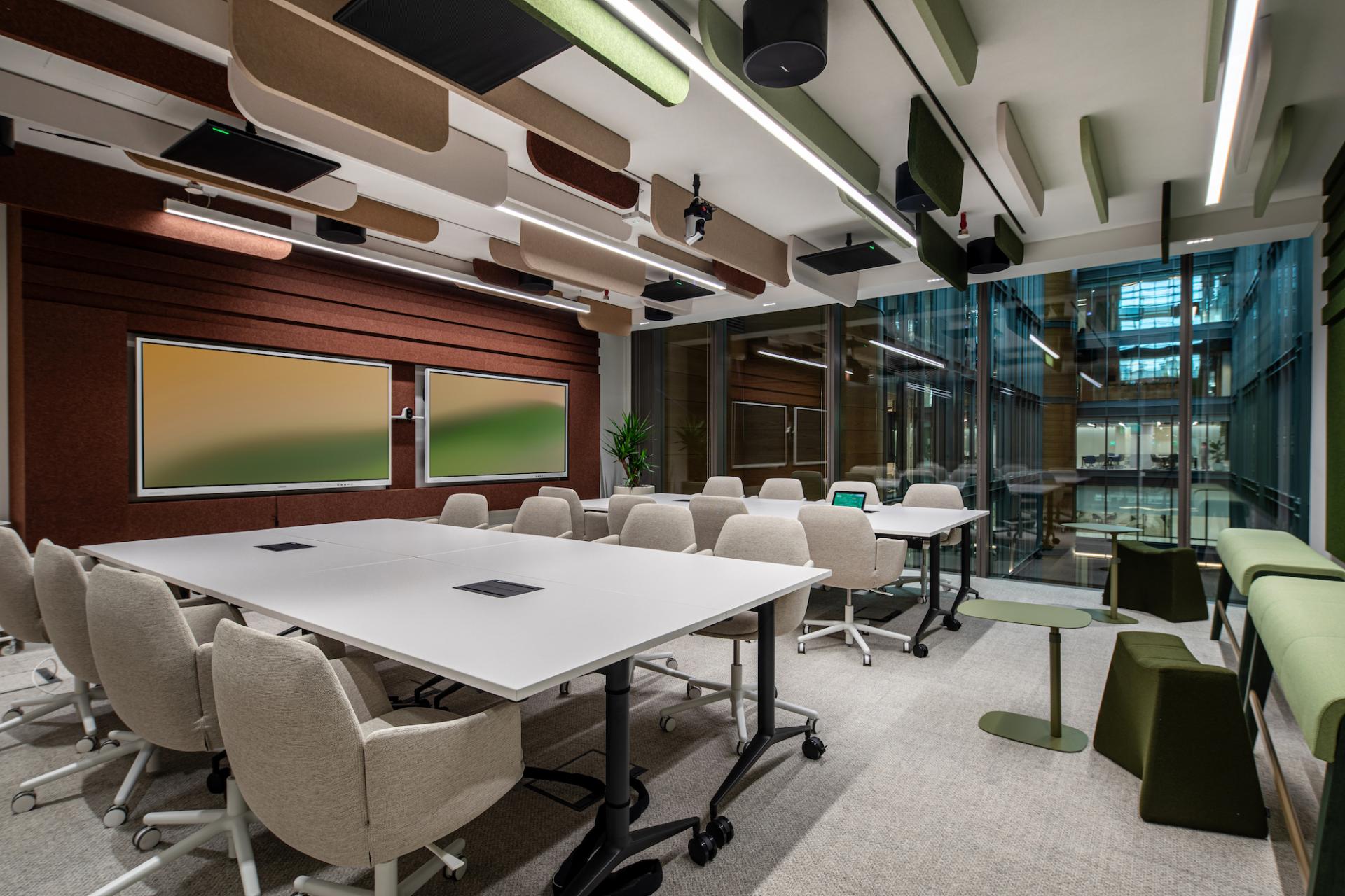 Brightly designed modern office meeting space in Dubai, showcasing nature-inspired colors and collaborative work areas.