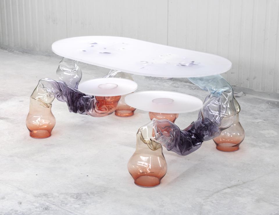Translucent coffee table with organic shapes and multicolored glass legs, part of Adorno's Matérialité collection from Paris Design Week.