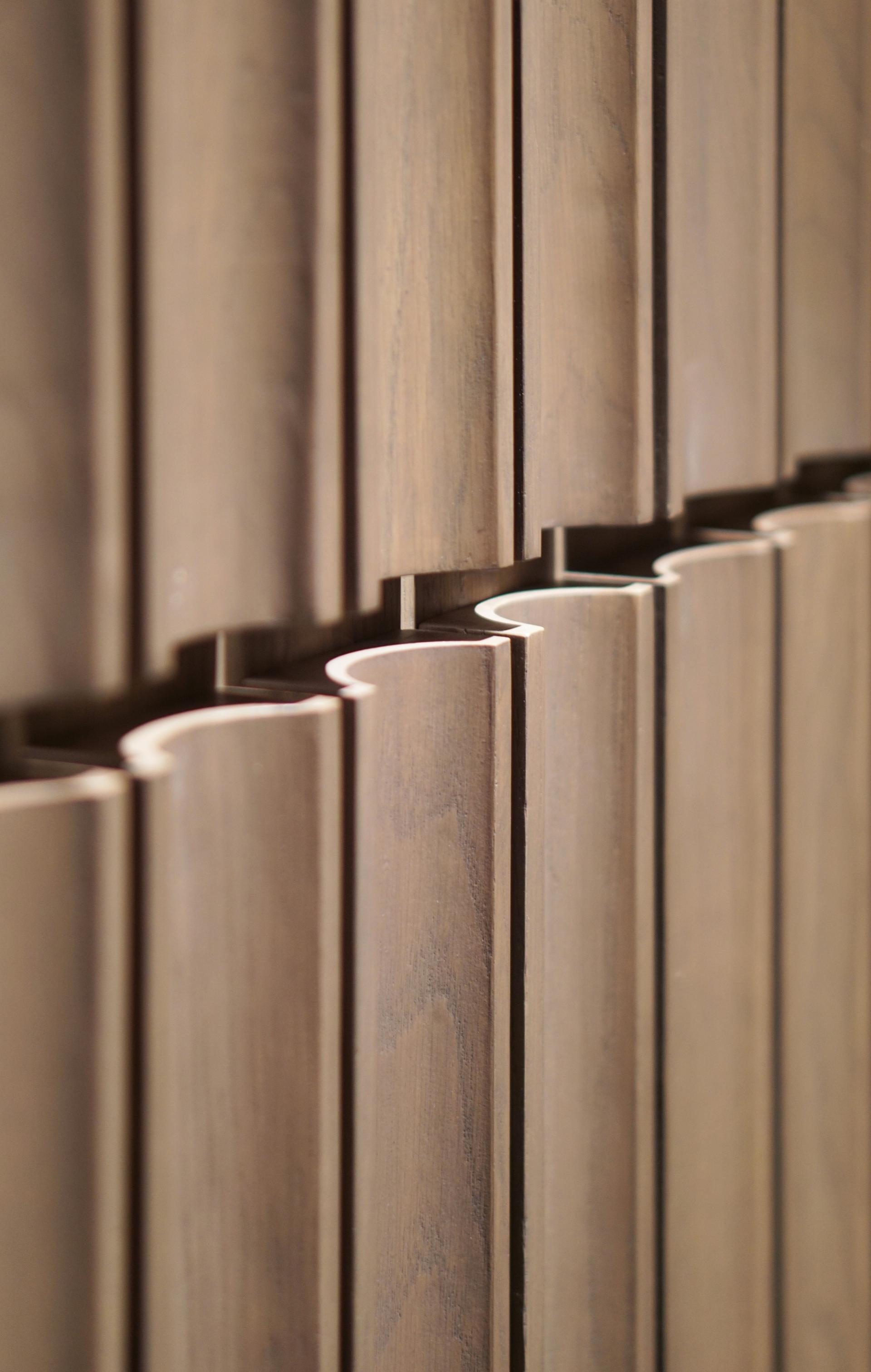 Textured wooden wall design from Warner Music Hong Kong's new headquarters by Bean Buro, showcasing modern aesthetic elements.