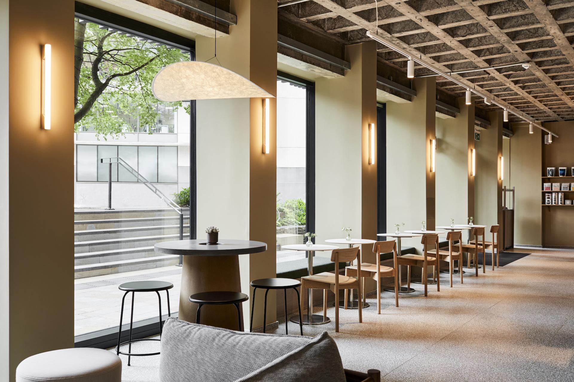 Modern café interior with seating, natural light, and minimalist design at Pollen Bakery, perfect for enjoying pastries.
