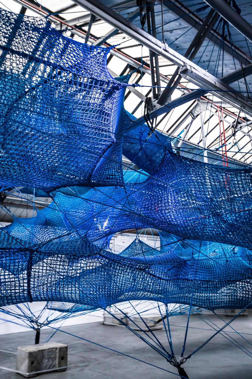Interactive blue net installation by Anya Hindmarch for The Weave Project, inviting visitors to explore its immersive design.