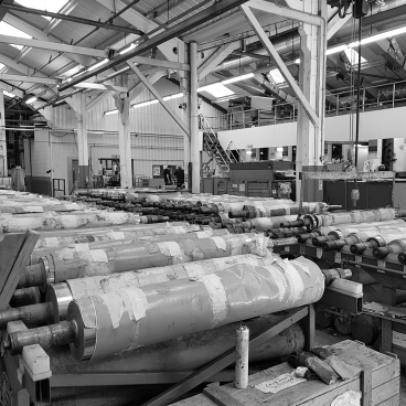 Production area at Muraspec factory, showcasing rolling machines and equipment for manufacturing wall coverings.