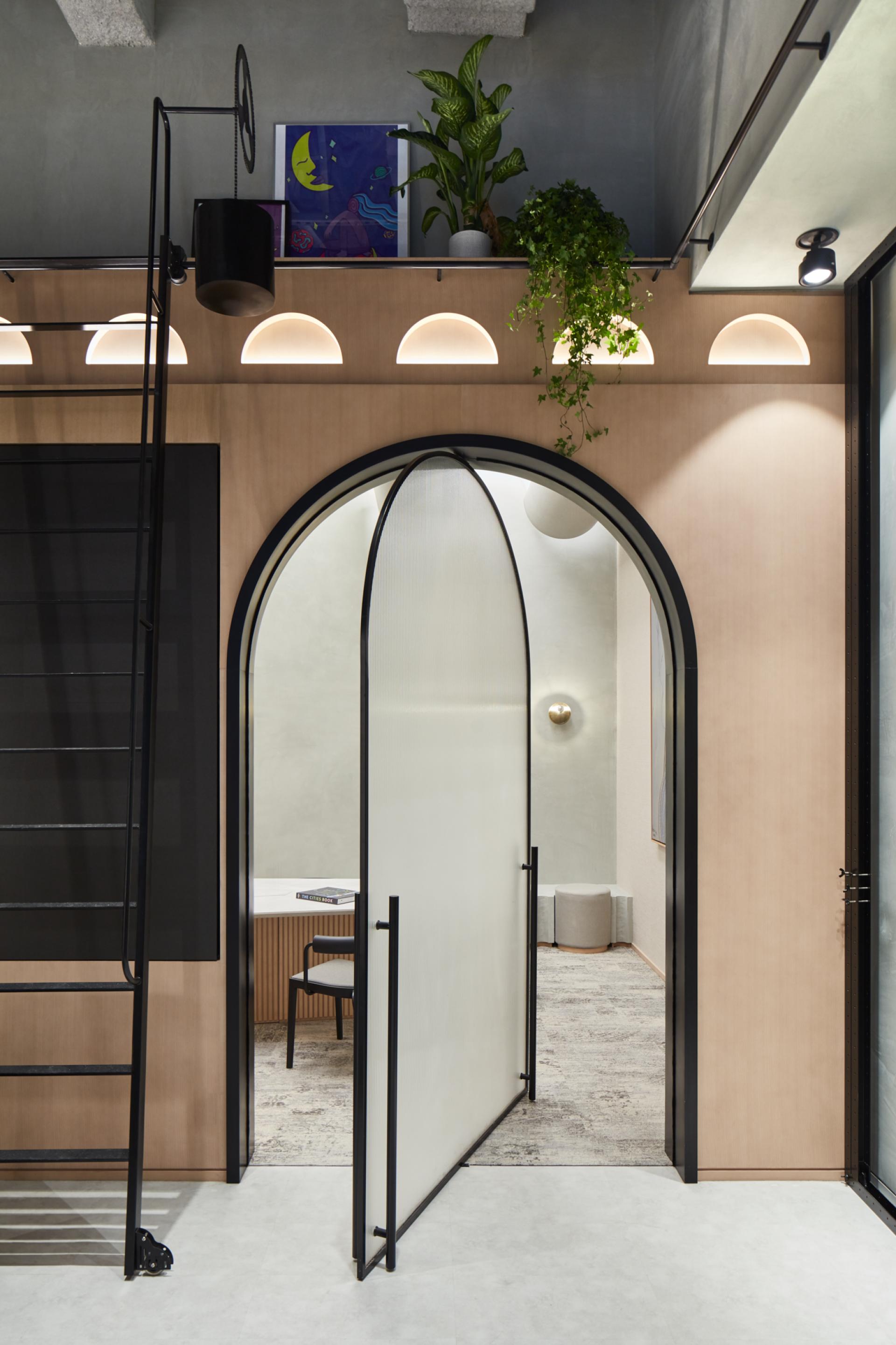 Interior view of Roar Studio’s Niche in Dubai, showcasing a modern design with arches, plants, and artistic decor.