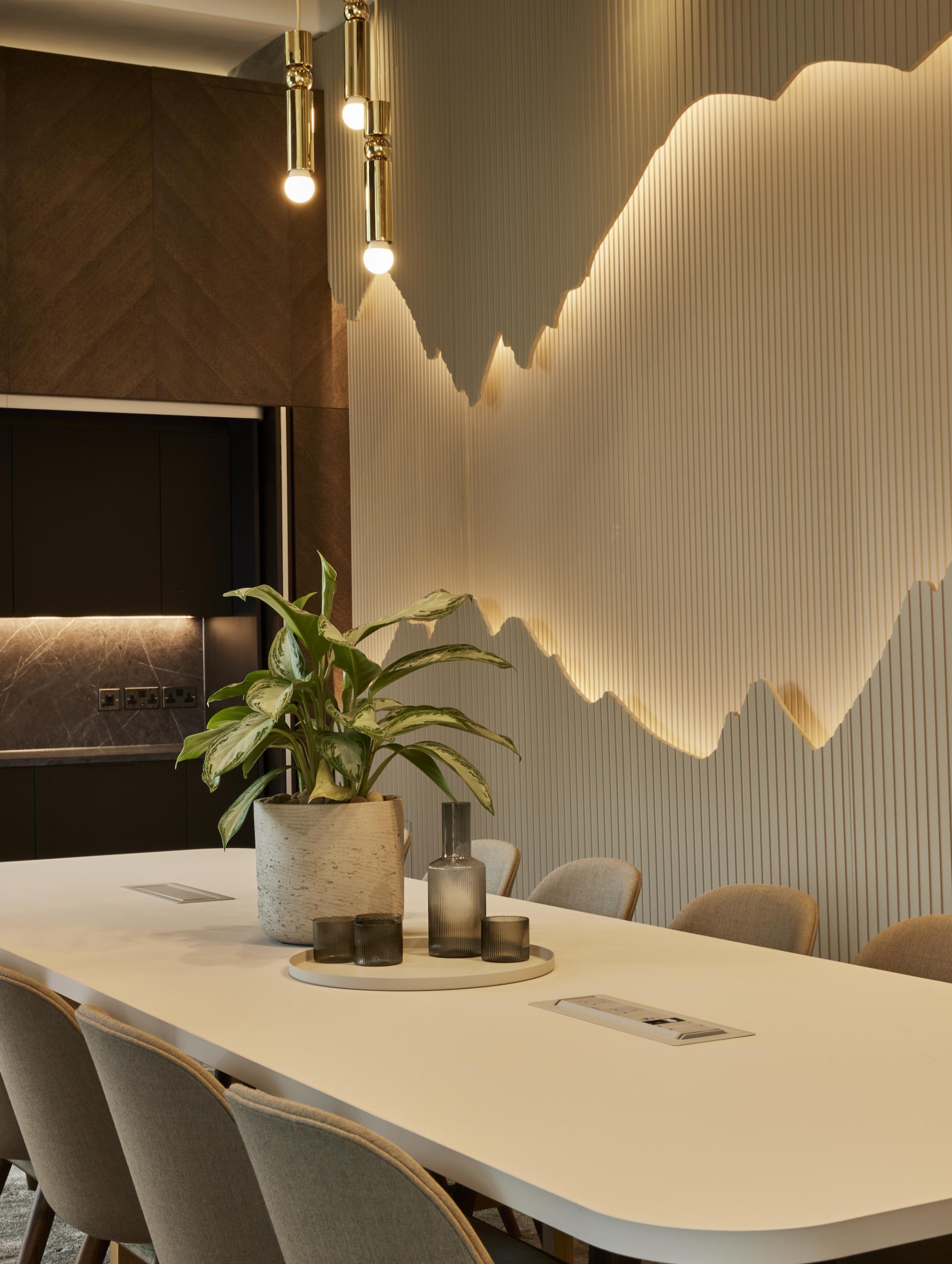 Modern residential amenity space designed by SpaceInvader featuring elegant lighting, greenery, and sophisticated furnishings.