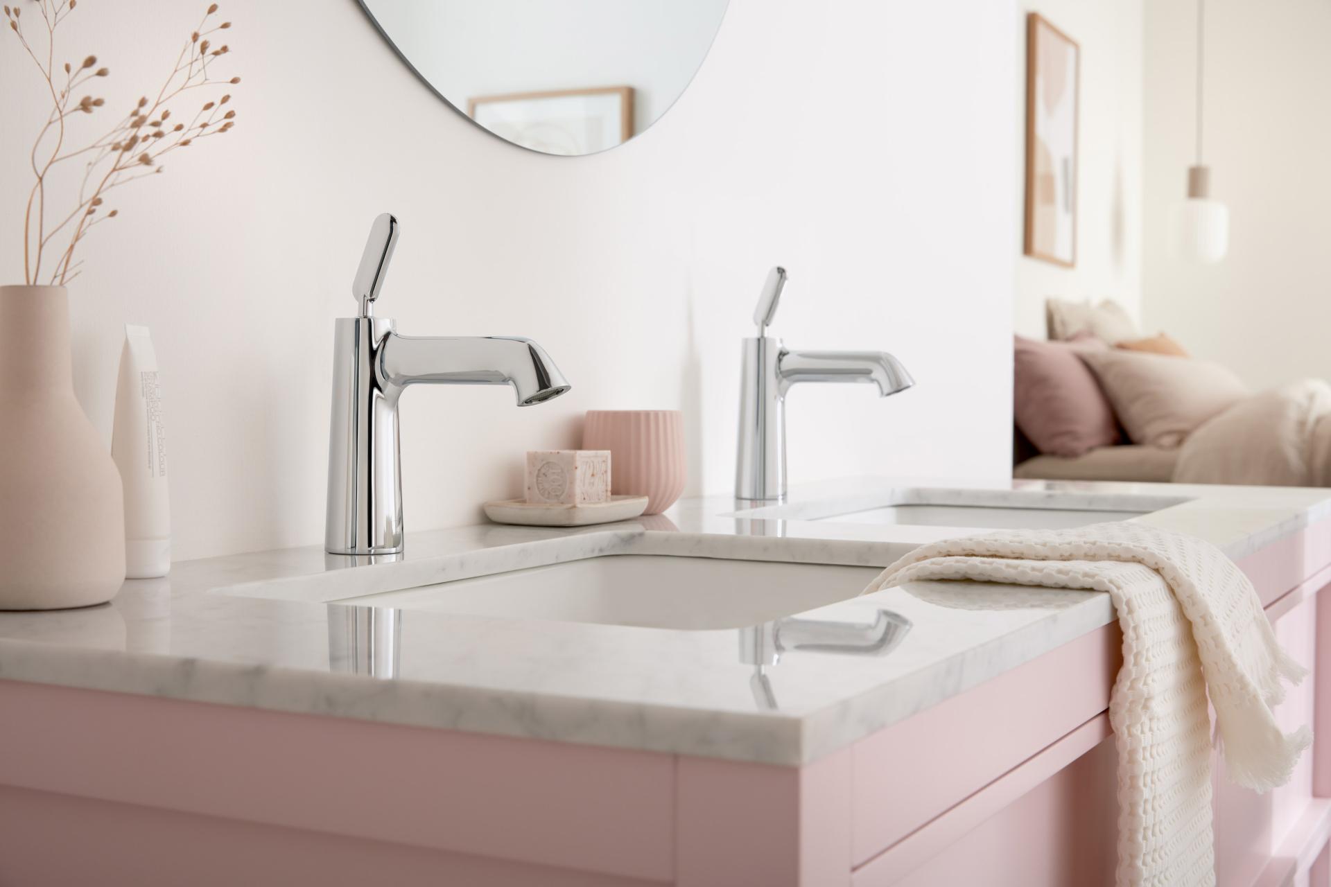 Stylish double bathroom sinks featuring VADO faucets, a sleek marble countertop, and decorative accents in a contemporary setting.