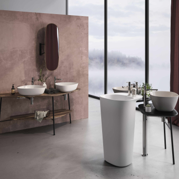 Modern bathroom featuring VitrA's Plural collection, showcasing elegant sinks and a freestanding tub against a stylish backdrop.