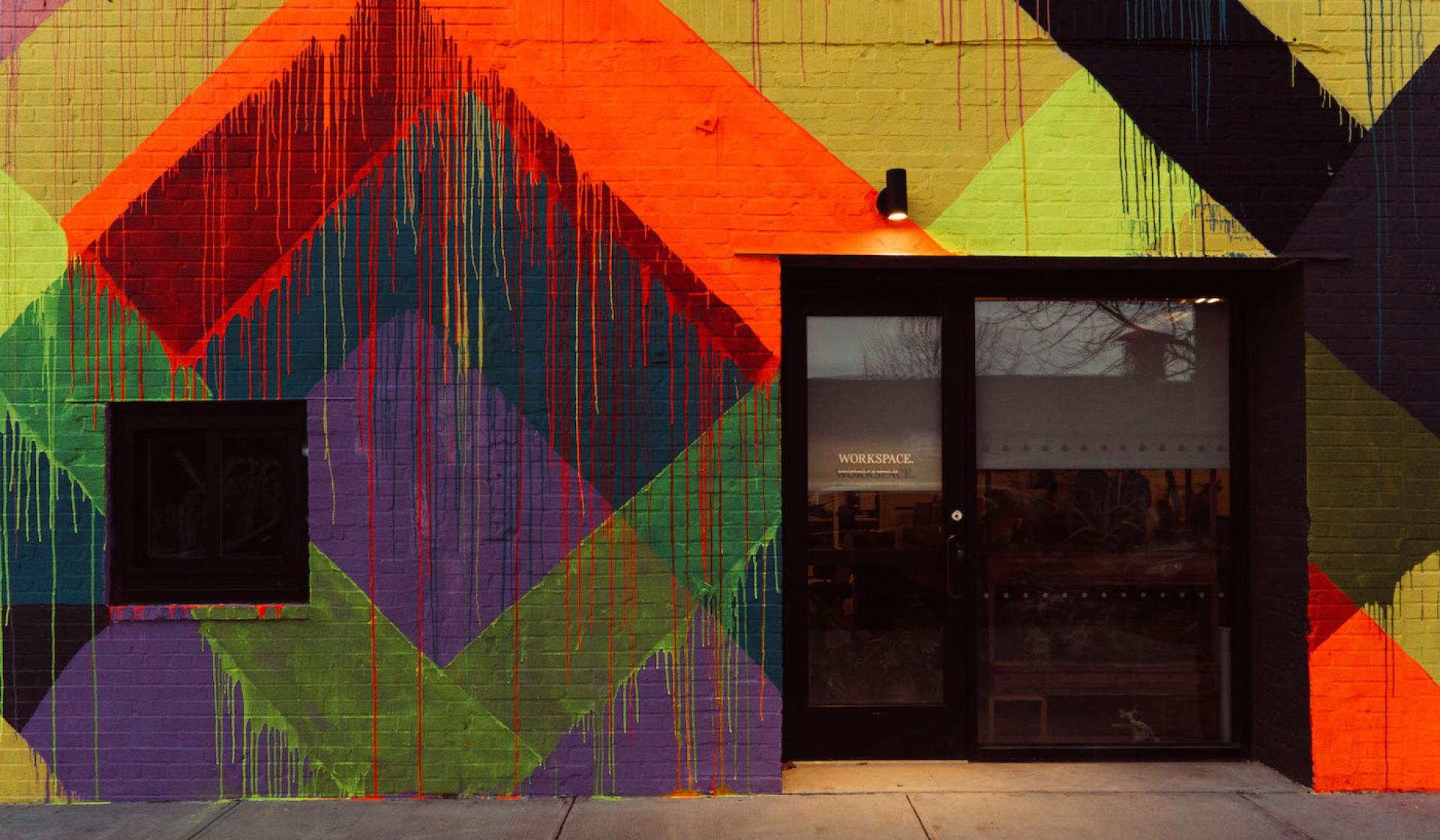 Vibrant urban mural featuring geometric shapes in bold colors, celebrating MINI's electric model launch through artistic expression.