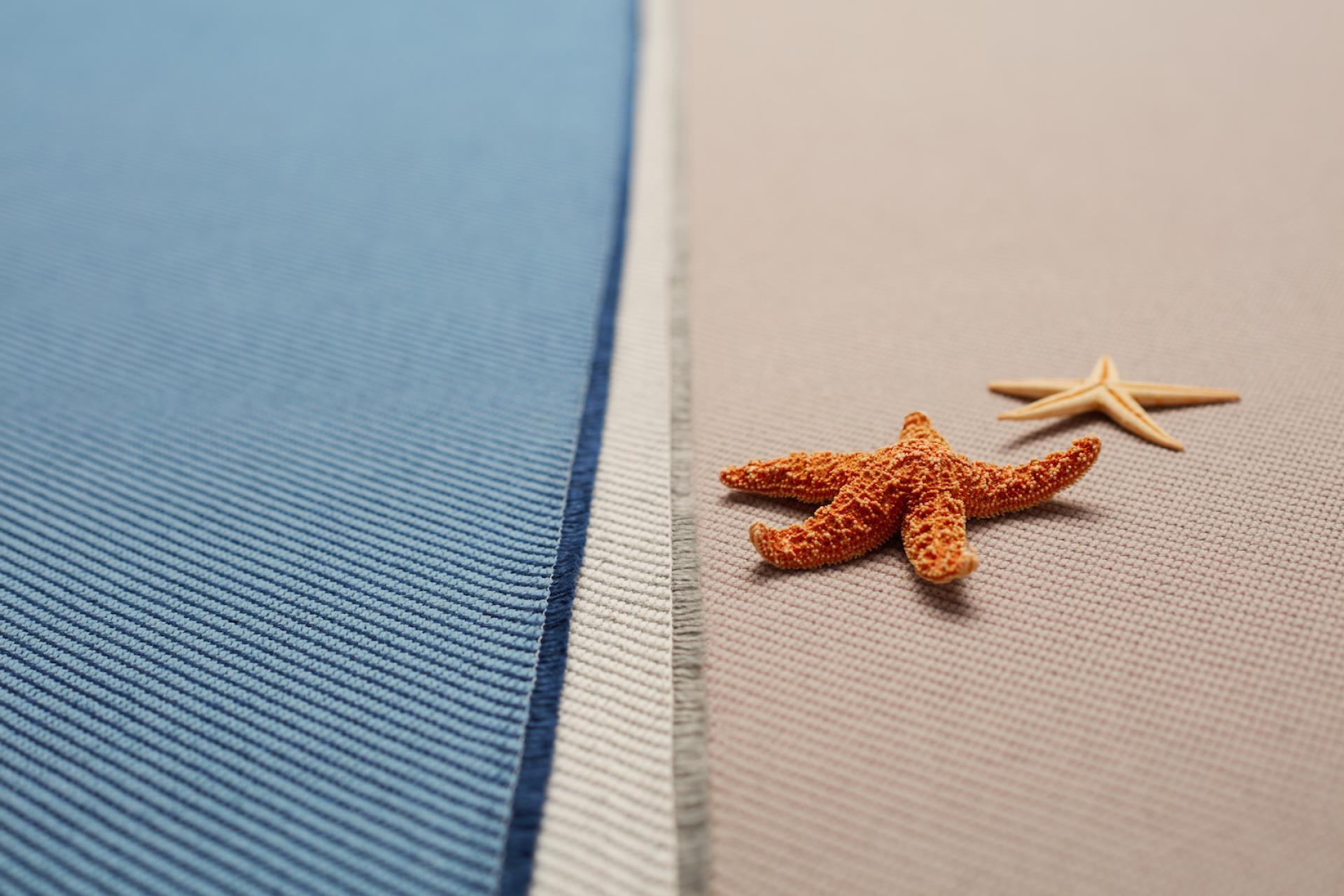 Textiles in ocean-inspired colors accompanied by starfish, depicting Camira's eco-friendly fabric made from recycled marine plastic.