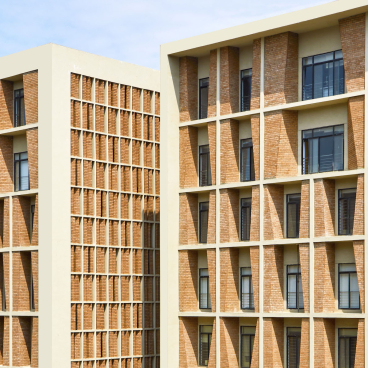 Contemporary architecture of Symbiosis University Hospital in Pune, showcasing textured brick facades and modern design elements.