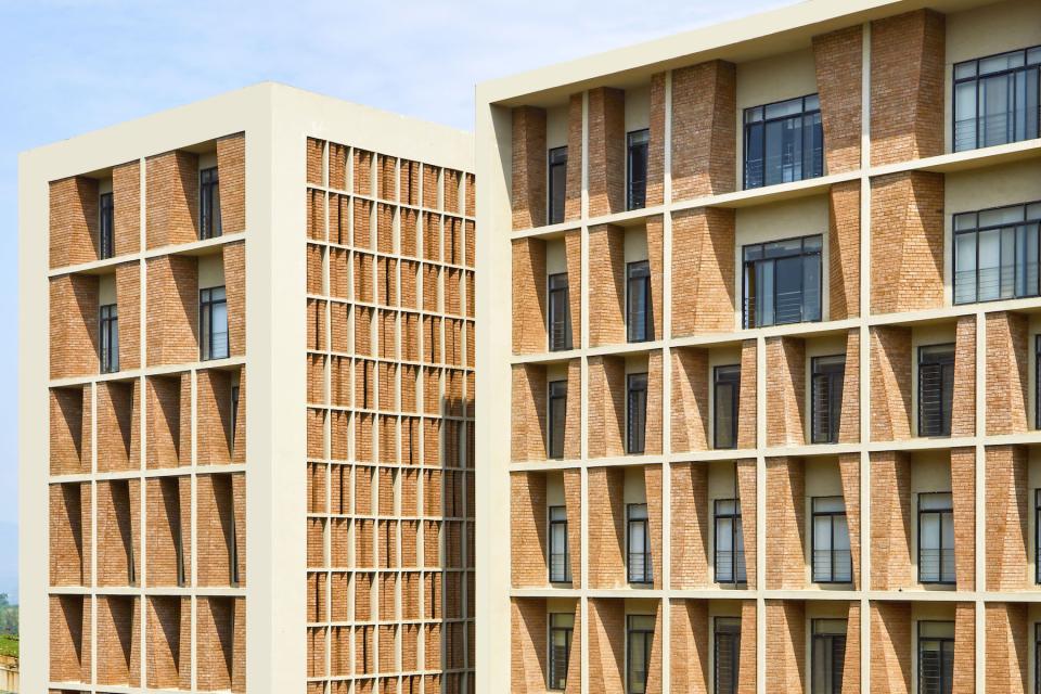 Contemporary architecture of Symbiosis University Hospital in Pune, showcasing textured brick facades and modern design elements.