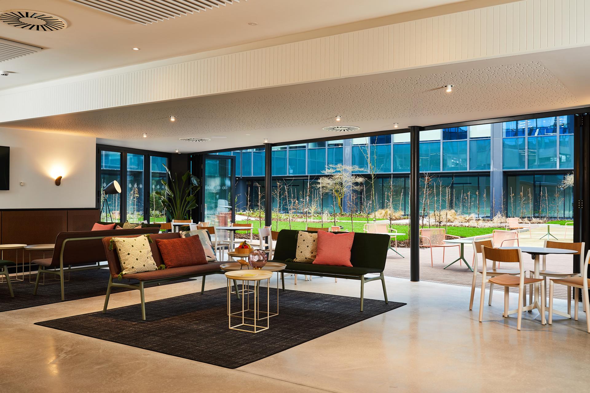 Modern interior design of Central House in Harrogate, featuring stylish seating and outdoor views, by SpaceInvader.