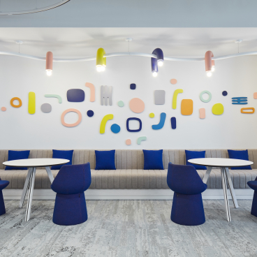Playful interior design featuring colorful wall accents and modern seating at the Early Childhood Authority headquarters in Abu Dhabi.