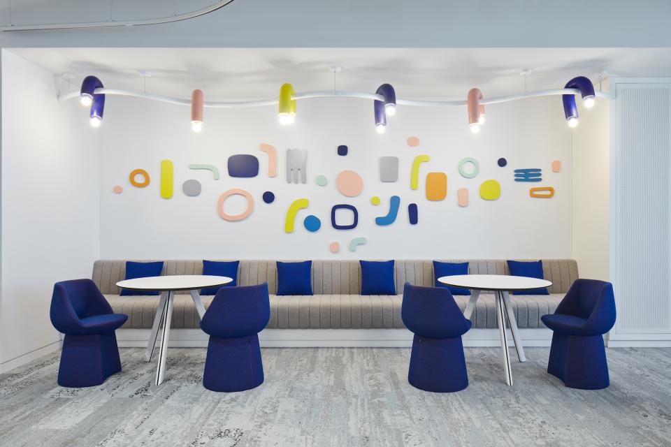 Playful interior design featuring colorful wall accents and modern seating at the Early Childhood Authority headquarters in Abu Dhabi.