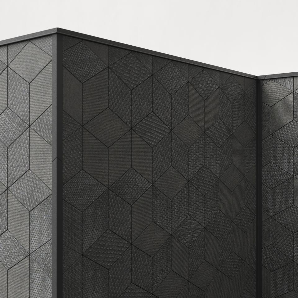 Stylish hexagonal ceramic tiles in dark tones by Mutina, showcasing a textured design in collaboration with OEO Studio.