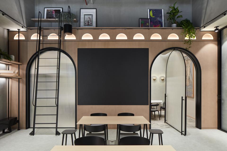 Contemporary interior of Roar Studio in Dubai featuring a versatile workspace with arched doorways and modern decor.