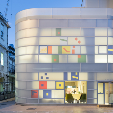 Modern architectural design of Maggie’s St Barts, showcasing colorful geometric patterns on the exterior.
