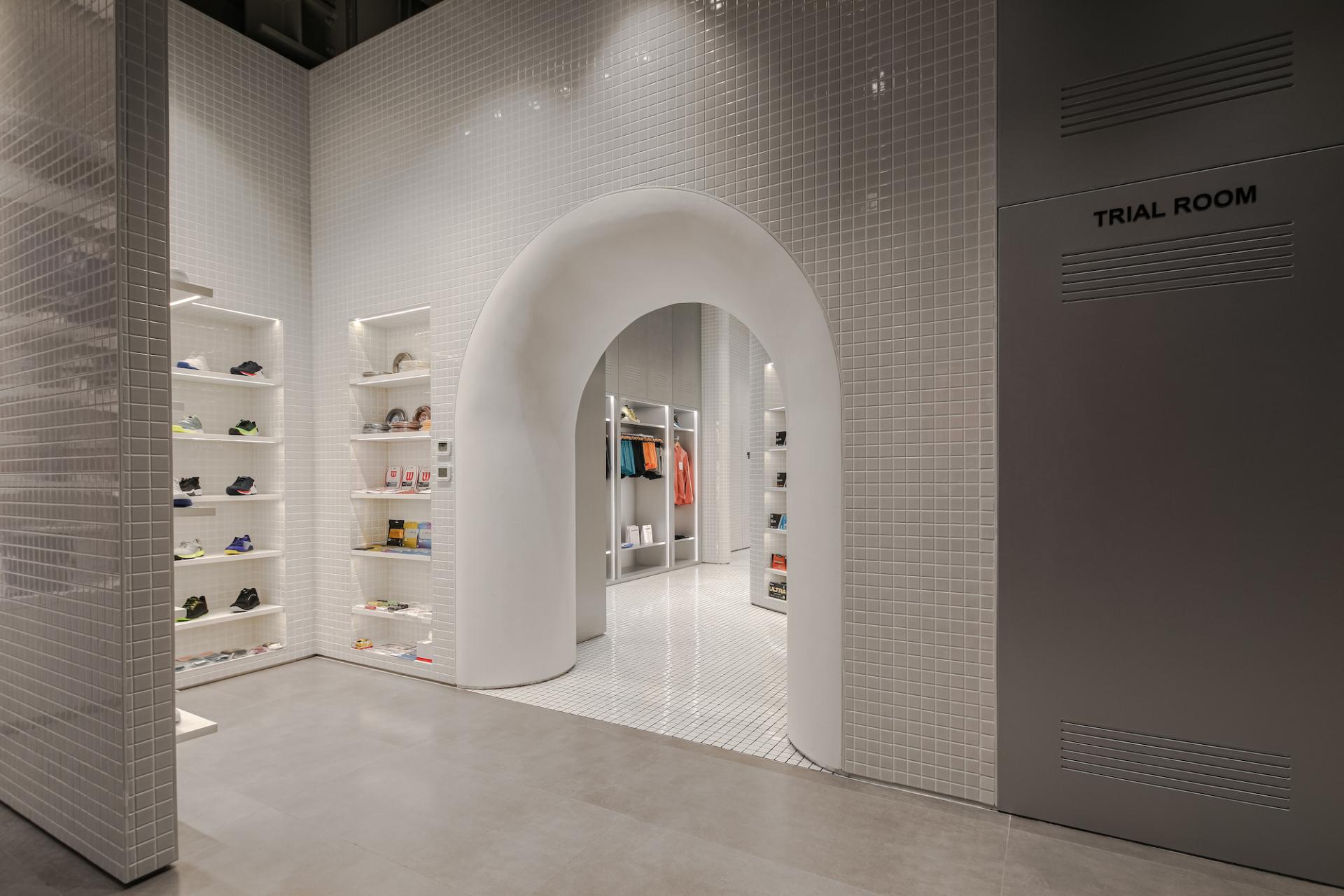 Modern underground concept store in Dubai featuring activewear displays, a trial room, and minimalist design elements.