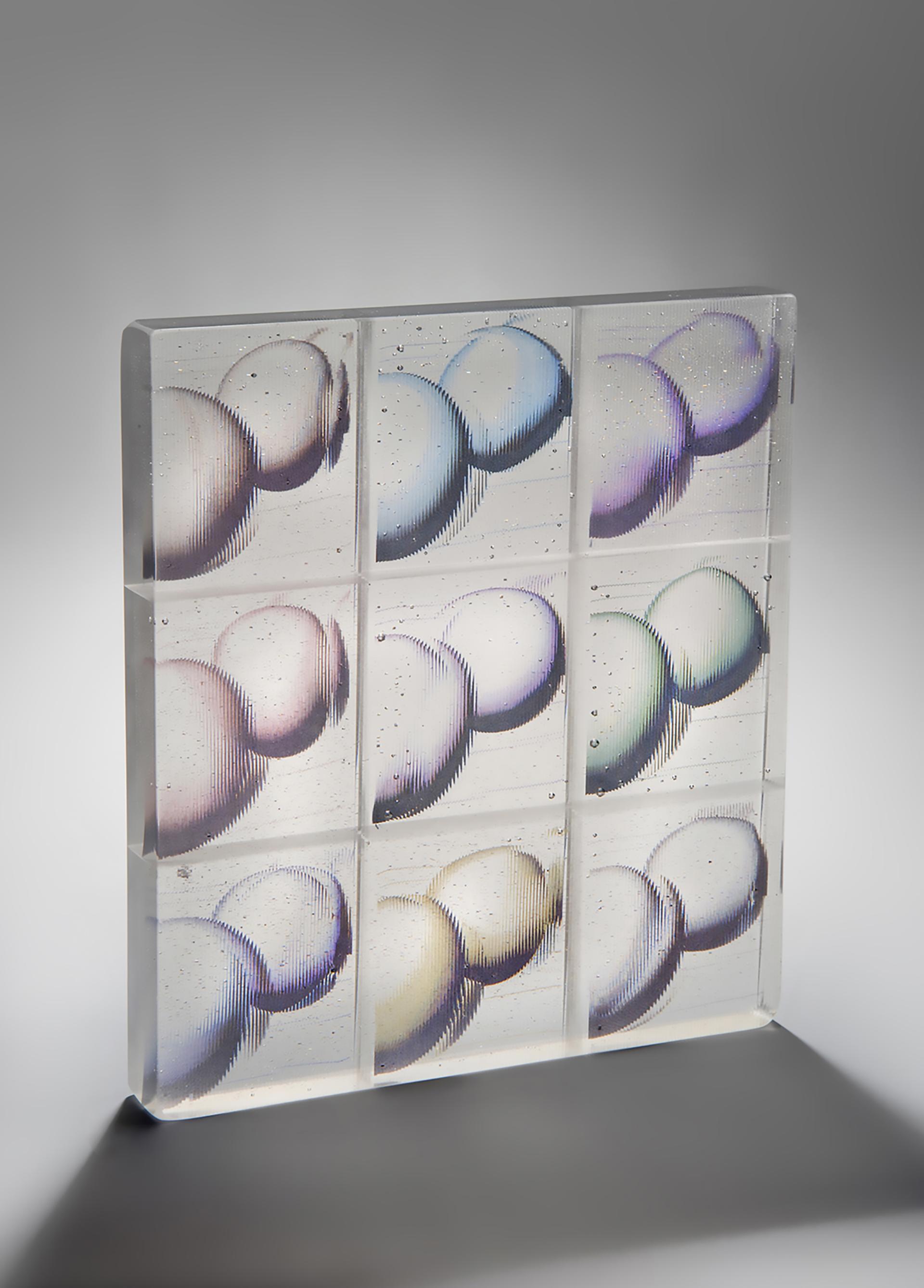 Colorful glass artwork featuring textured circles, showcasing the intersection of design and craftsmanship by Design Nation.