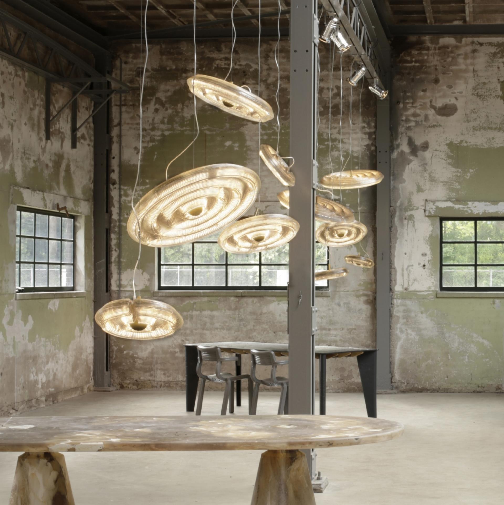 Sustainable design installation featuring unique hanging light fixtures in a textured industrial space at London Design Festival 2018.