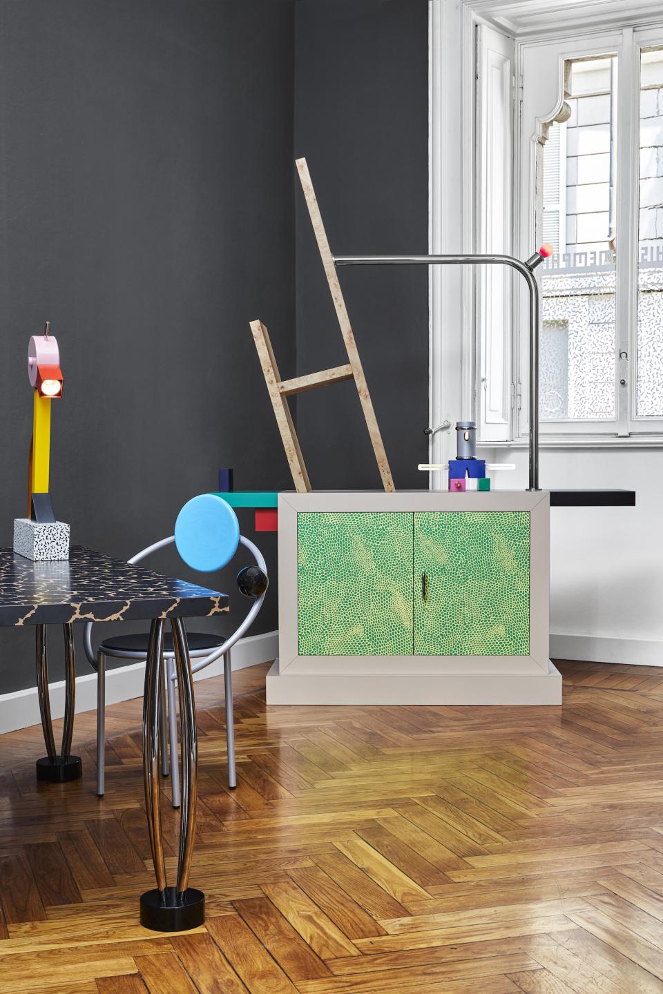 Vibrant Memphis Milano furniture design showcased in a stylish interior featuring colorful lamps and artistic cabinetry.