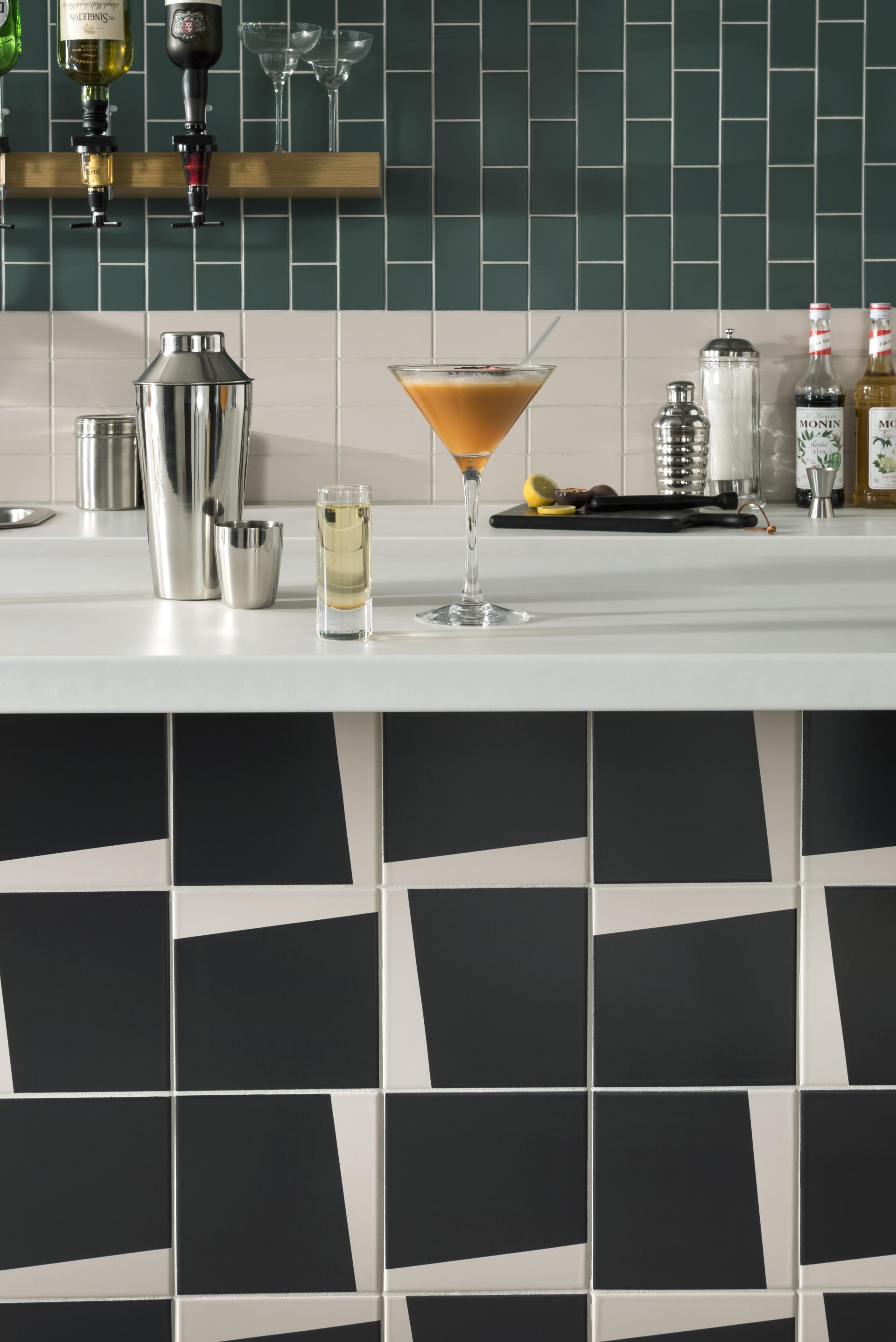 Contemporary bar area featuring Tom Pigeon-designed tiles, cocktail glasses, and beverage accessories at Parkside's flagship studio.