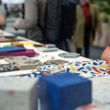 Showcasing colorful material samples and designs at the Surface Design Show 2022, emphasizing sustainable design trends and creativity.