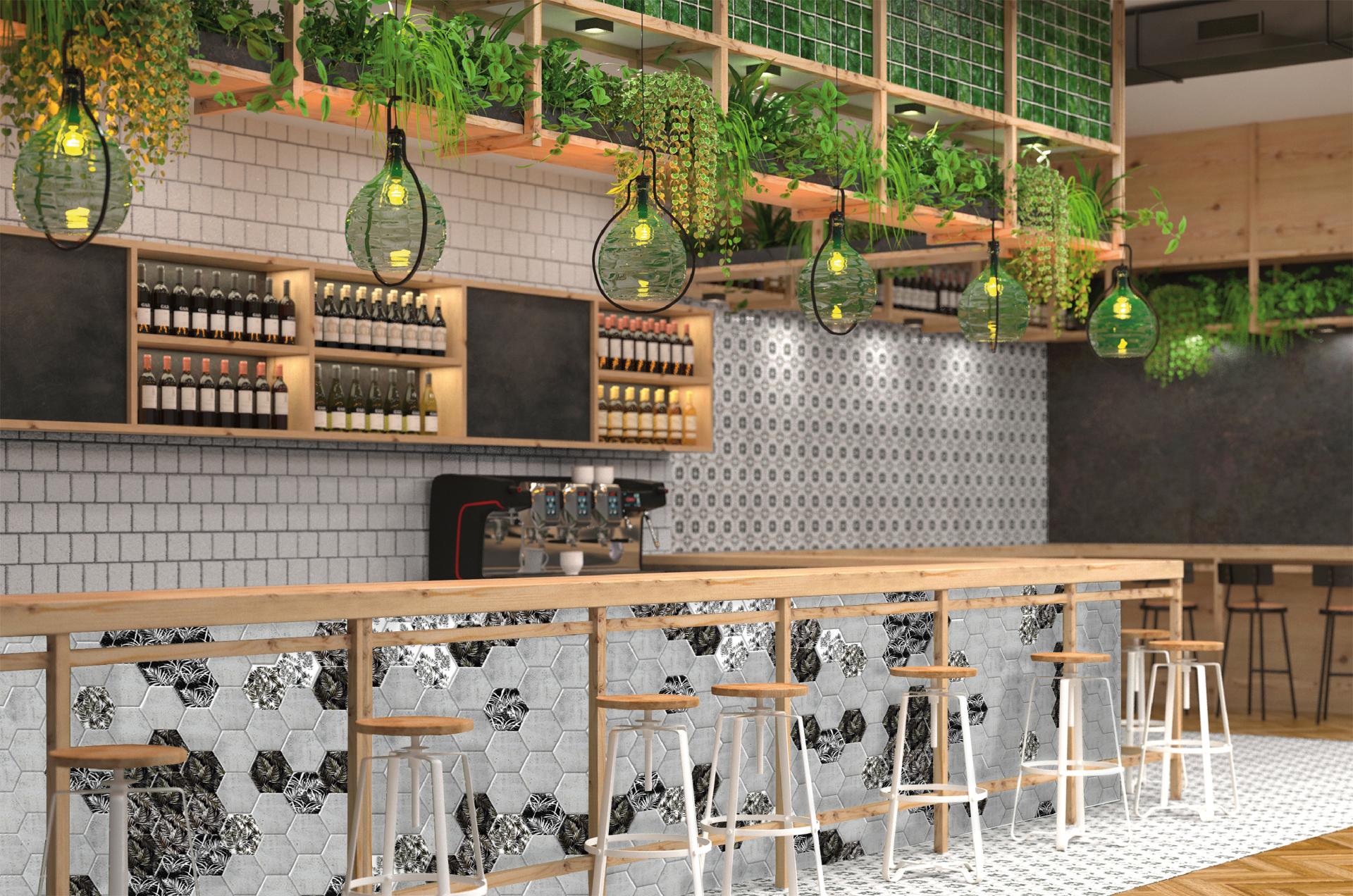 Stylish bar area featuring hexagon tiles, wooden accents, and greenery, showcasing maximalist design trends from Cevisama 2019.