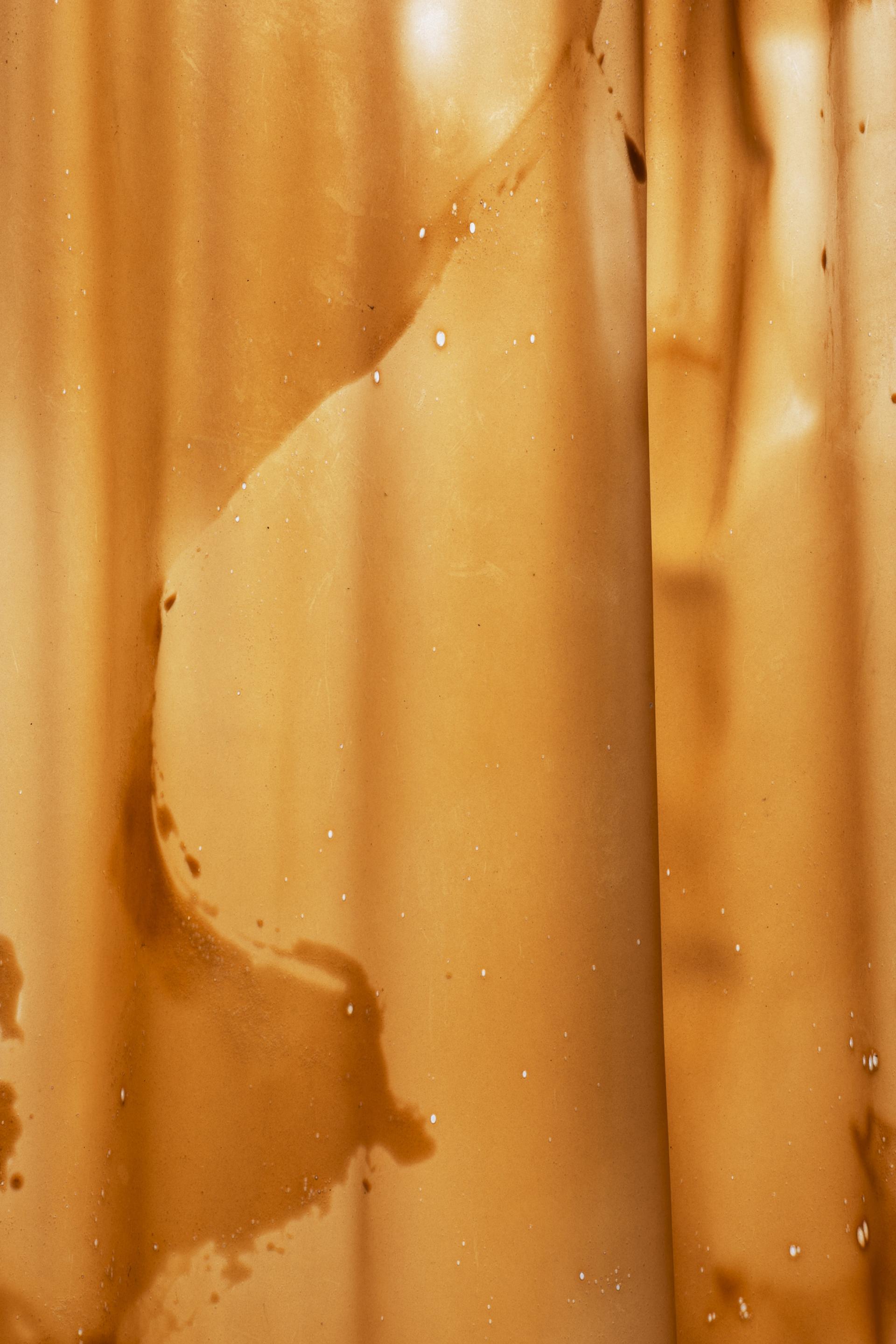 Textured surface of salvaged materials, showcasing organic shapes and earthy tones used in sustainable store design by Nina+Co.