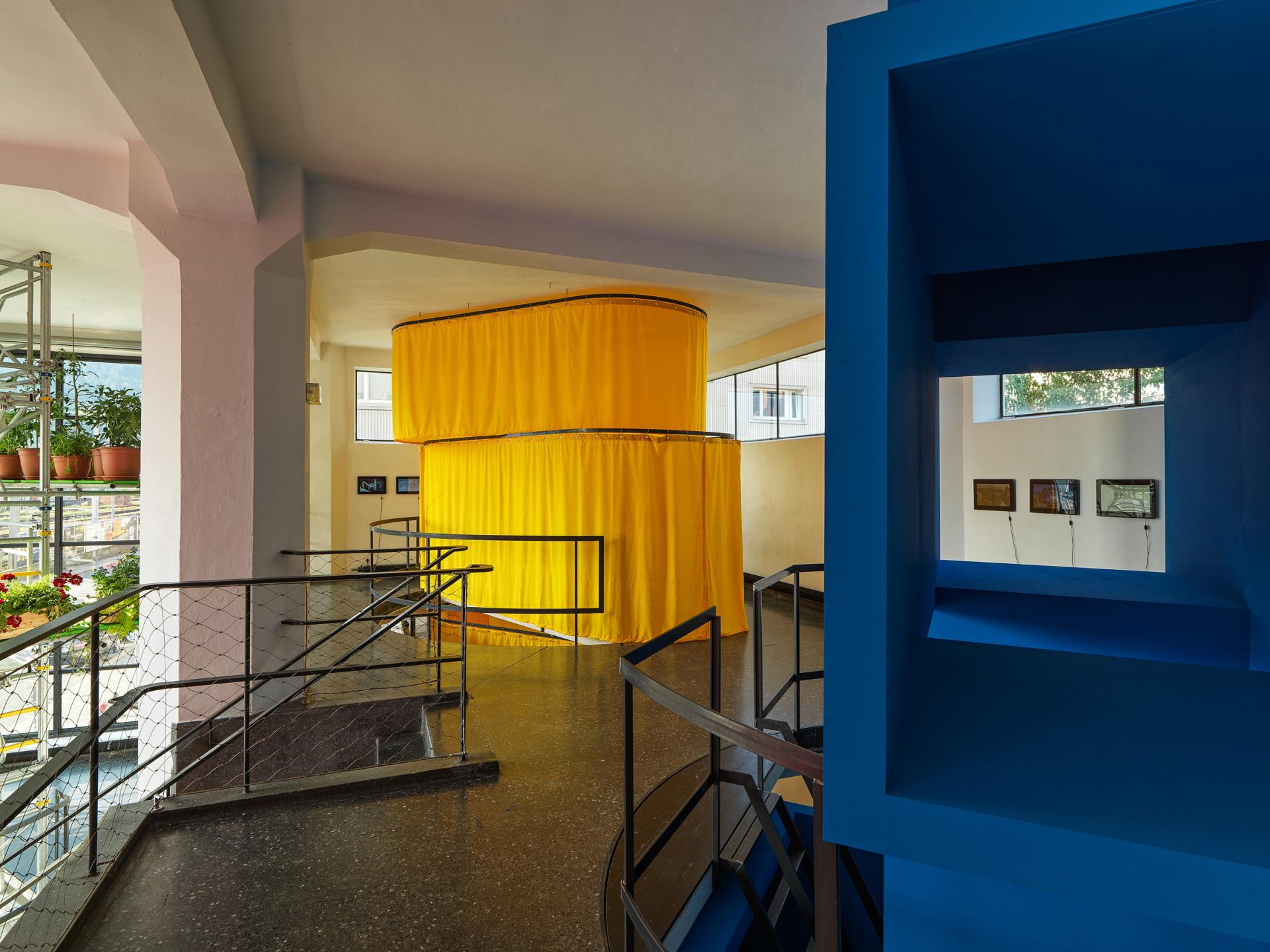 Colorful installation by MVRDV featuring yellow and blue elements, showcased in the Architecture Speaks exhibition space.