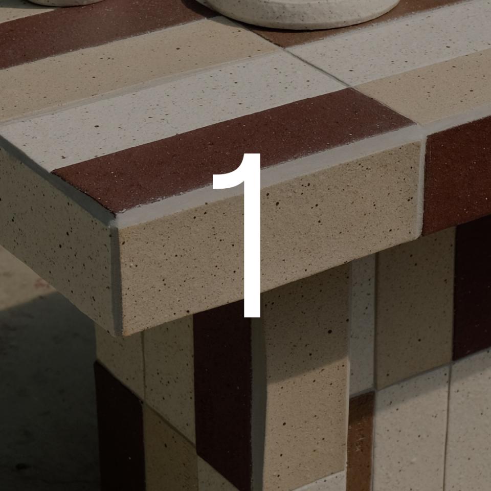 ReCinder table showcasing sustainable design with 100% recycled ceramic and waste ash materials in varied colors.