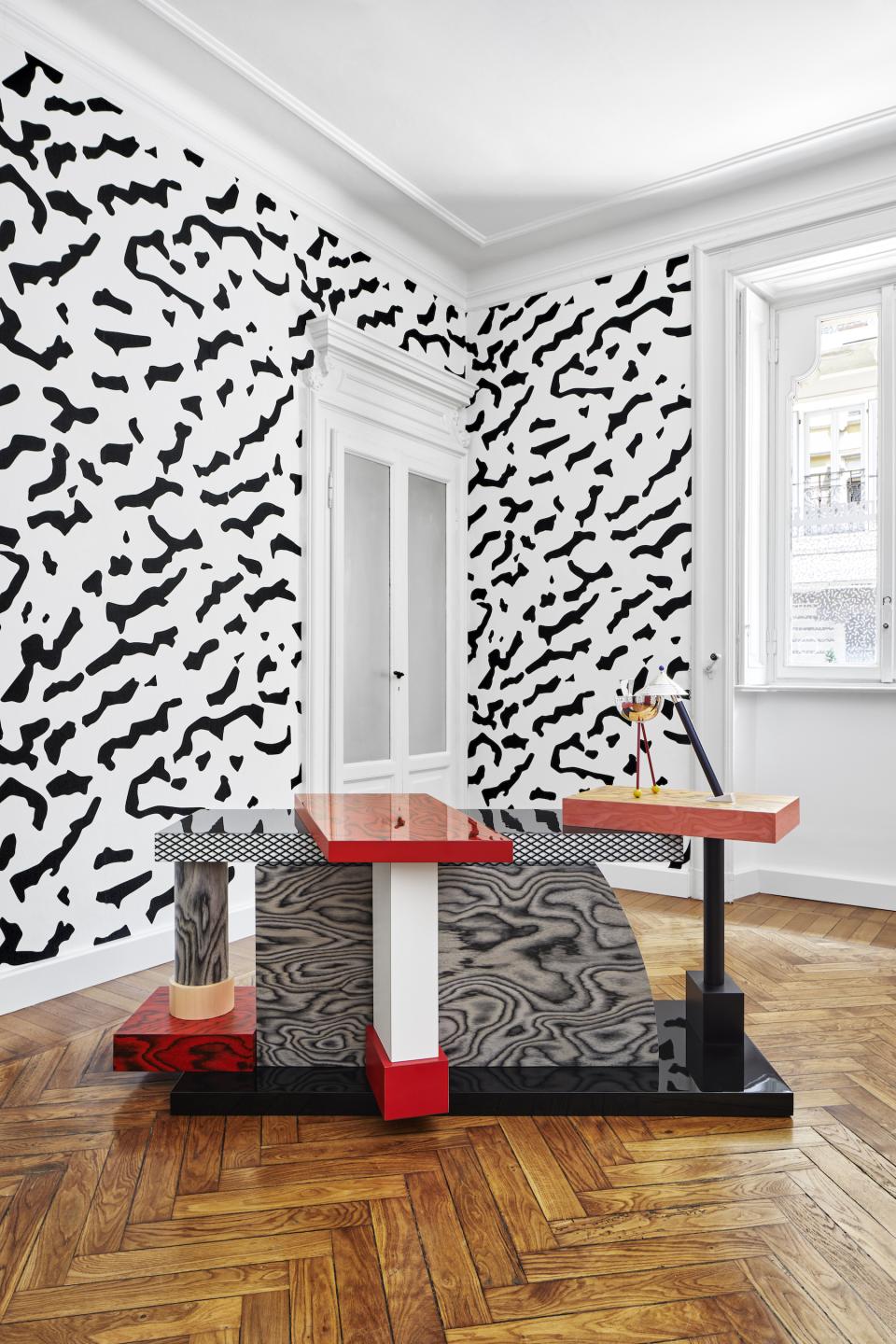 Interior showcasing distinctive Memphis Milano design, featuring abstract patterns and bold furniture in a stylish Brera setting.