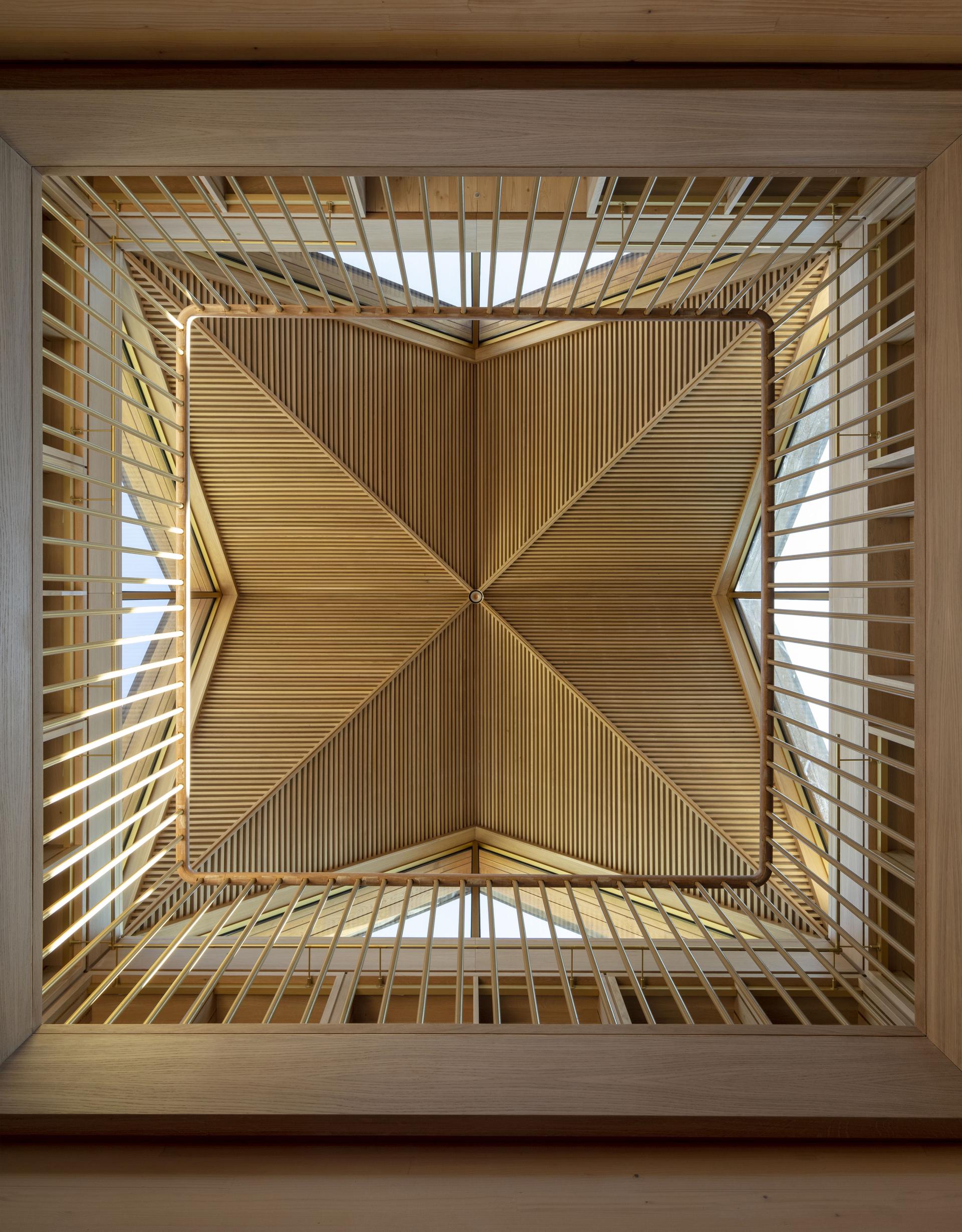 Intricate wooden ceiling with cross-laminated timber and slatted design, featured in RIBA's 2022 Stirling Prize shortlist.