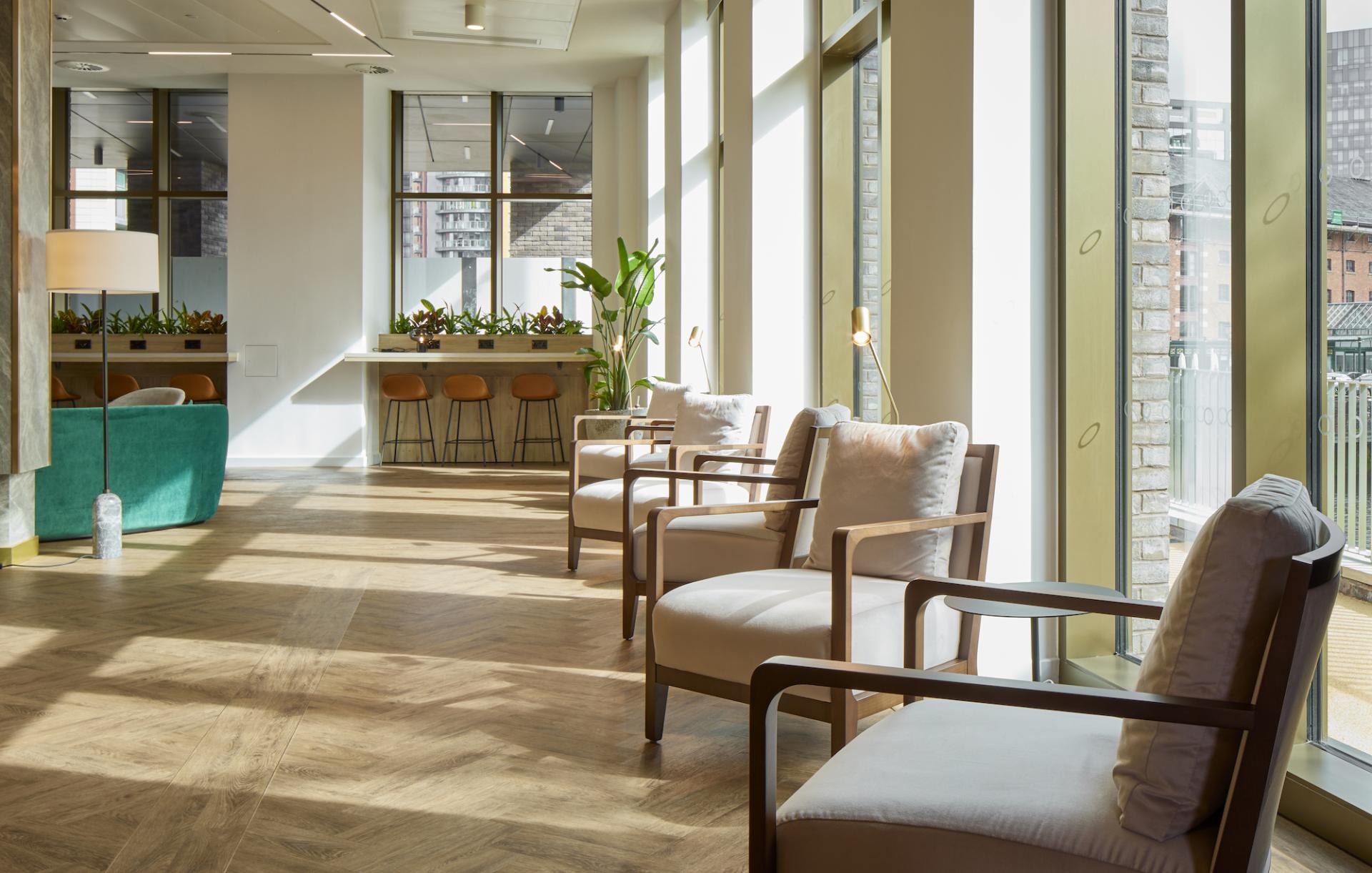 Modern residential amenity space designed by SpaceInvader, featuring stylish seating, large windows, and a welcoming atmosphere.