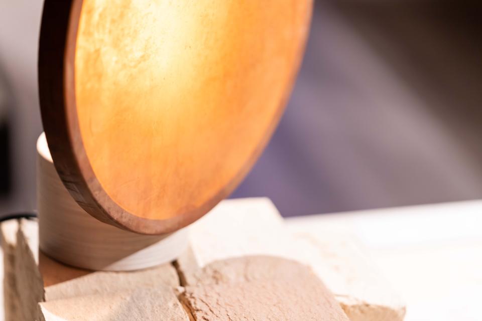 Biomaterial lamp design radiating warm light, featured in the 'From The Ground Up' exhibition at Material Source Studio.