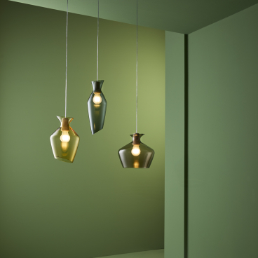 Elegant blown glass pendant lamps in green tones, showcasing rounded shapes and artistic design, perfect for modern interiors.