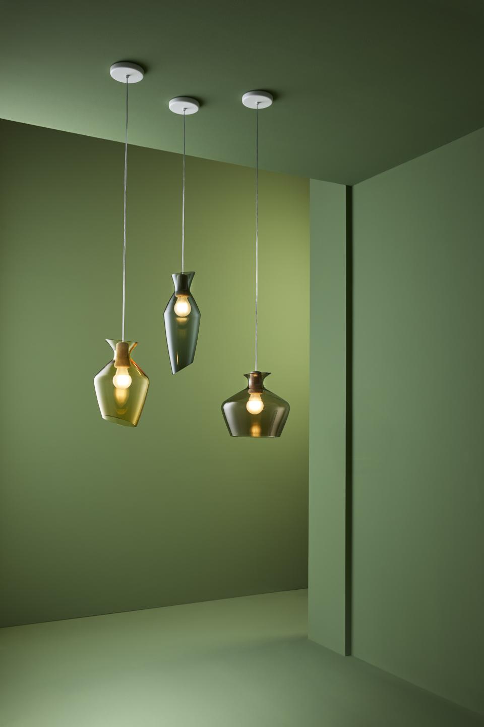 Elegant blown glass pendant lamps in green tones, showcasing rounded shapes and artistic design, perfect for modern interiors.