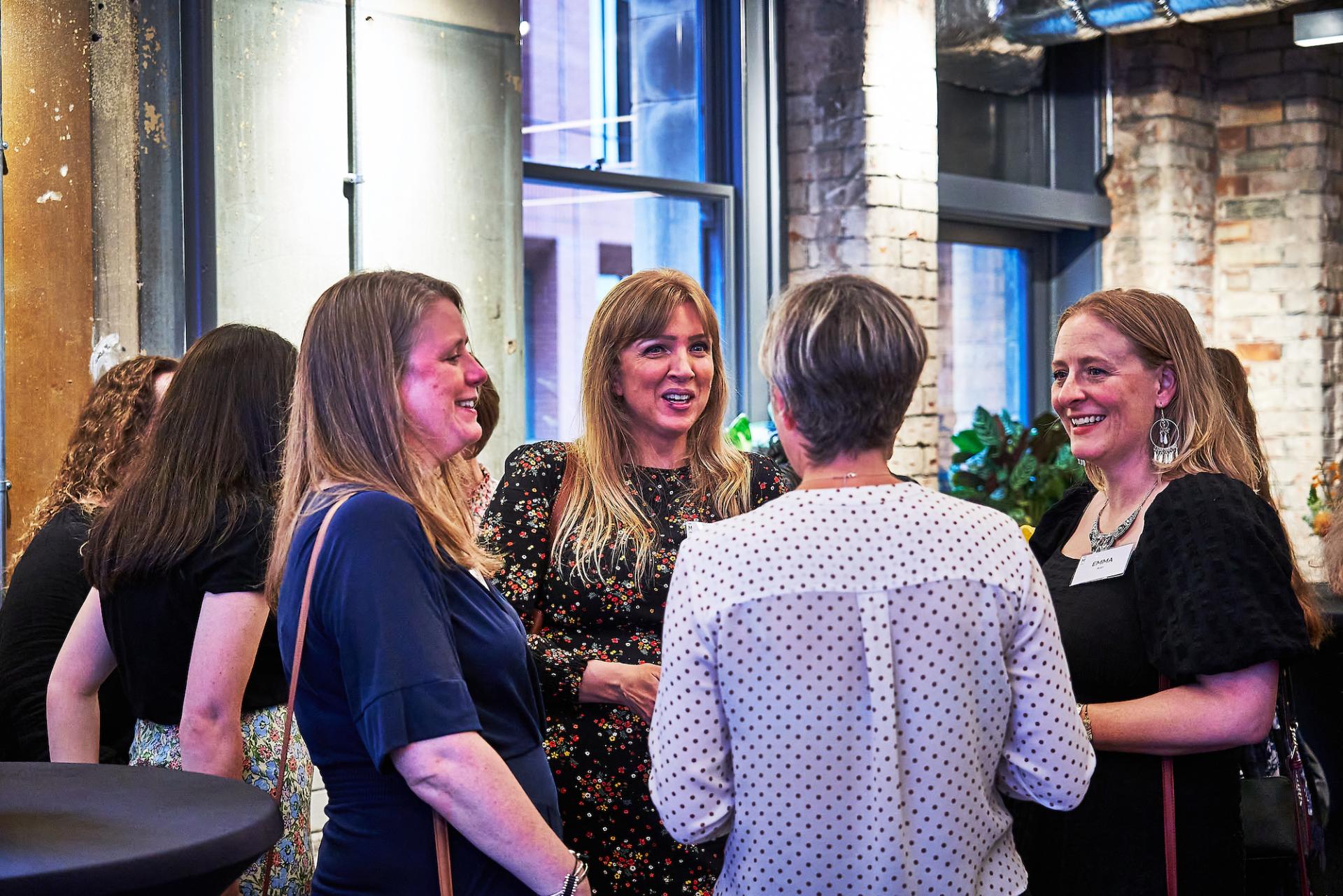 Networking event featuring diverse attendees engaged in conversation, celebrating the podcast 42 Roles in the Built Environment.