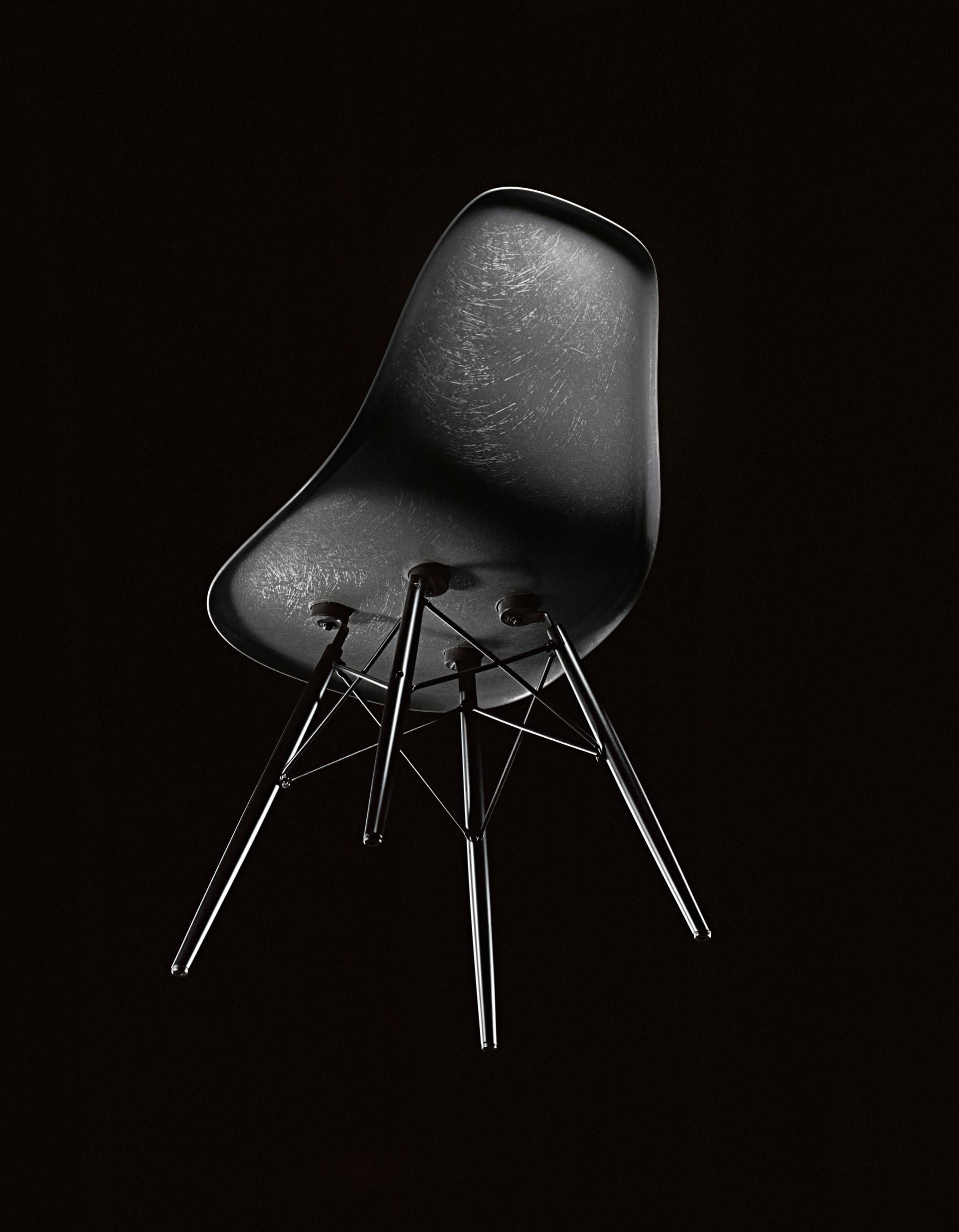 Elegant black Eames chair showcased against a dark background, highlighting its modern design for the London Design Festival.