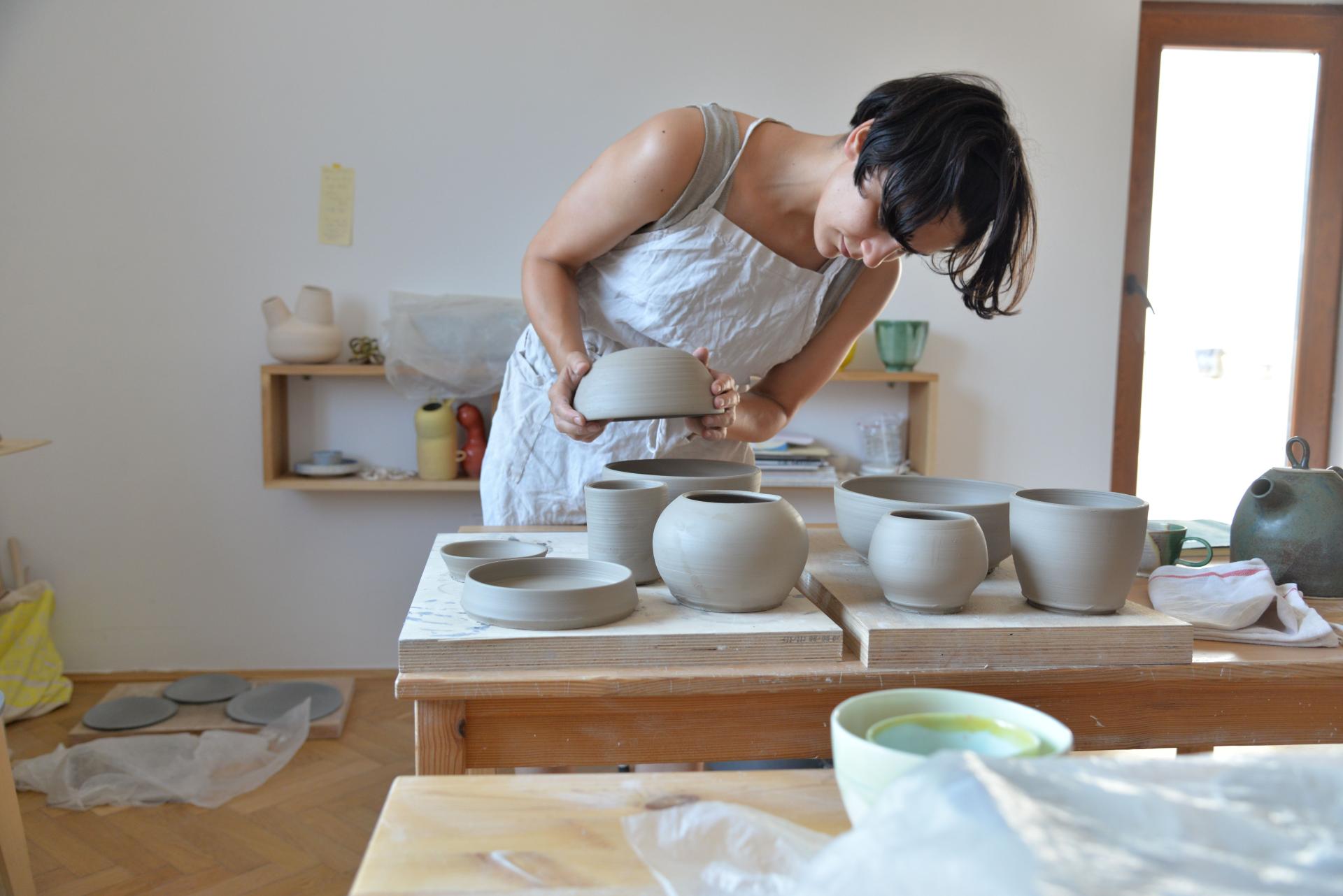 Bucharest ceramicist Sandra Berghianu shapes functional and sculptural pottery in her studio, showcasing her artistic process.