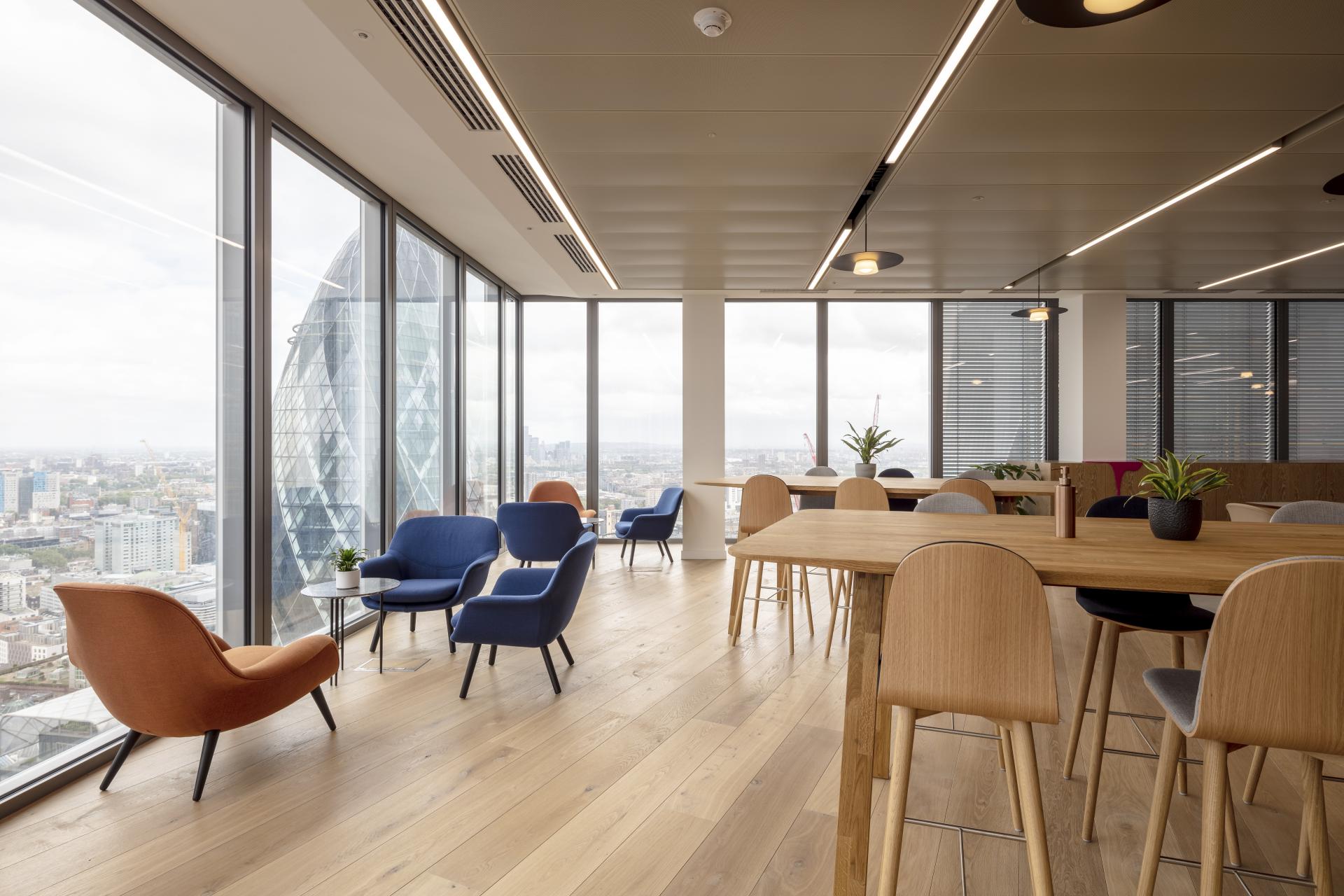 Modern office space at 22 Bishopsgate featuring stylish furniture, wooden flooring, and expansive city views, designed by BW: Workplace Experts.
