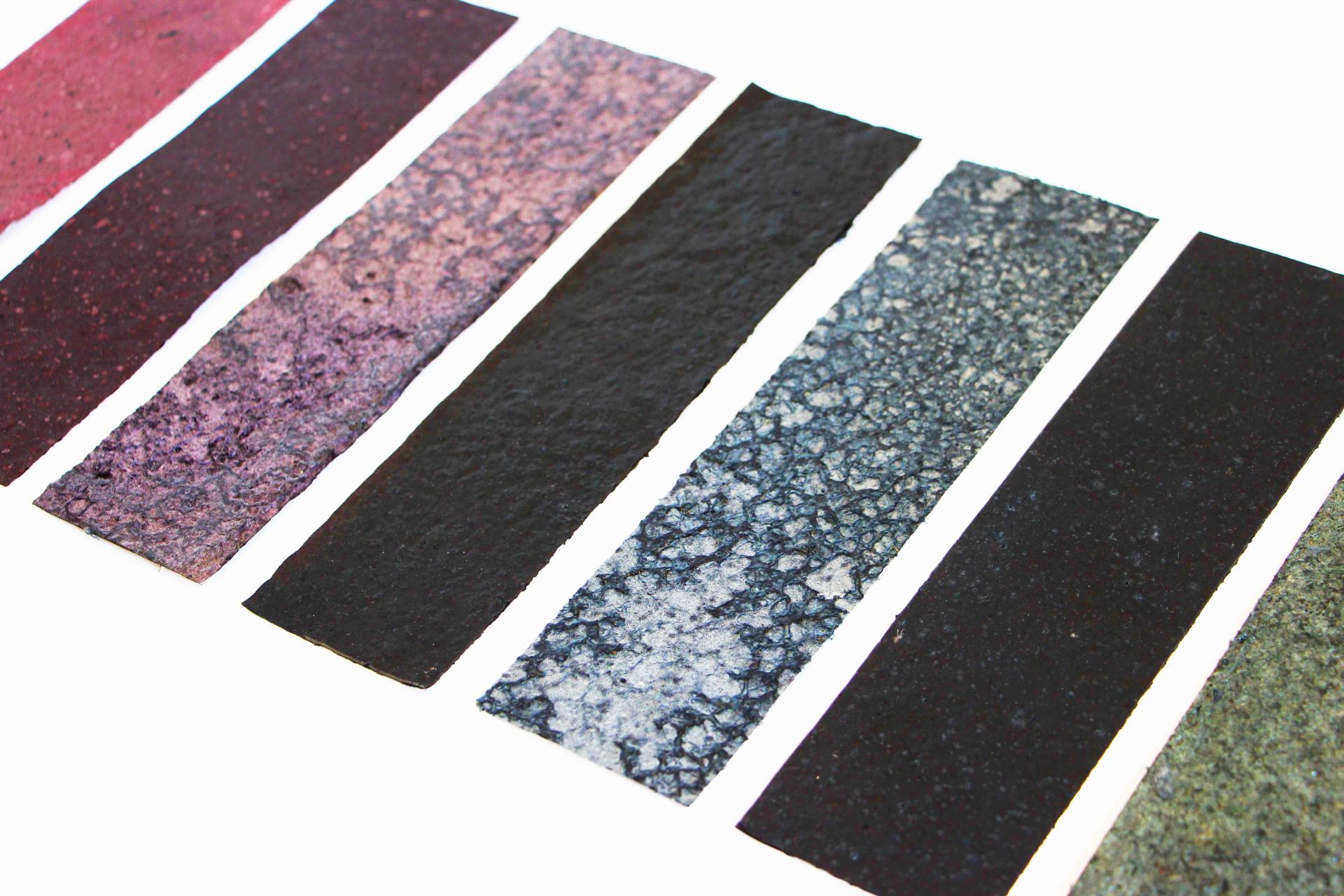 Colorful strips of BioMarble material showcasing texture and variation, highlighting innovative design in sustainable materials.